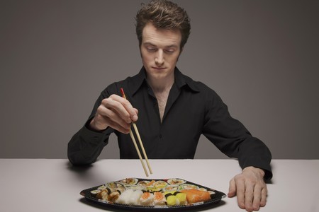 Man having a sushi set mealの写真素材