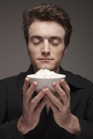 Man holding a bowl of white riceの写真素材