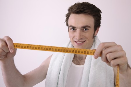 Man holding tape measureの写真素材