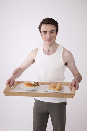 Man holding a tray with breakfastの写真素材