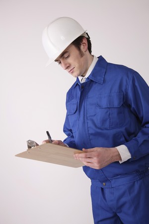Man writing on clipboardの写真素材