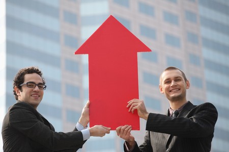 Businessmen with arrow sign pointing upの写真素材