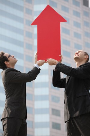 Businessmen with arrow sign pointing upの写真素材