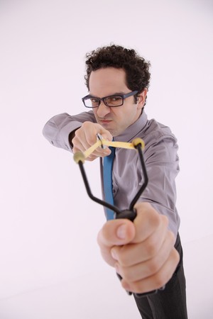 Businessman aiming slingshotの写真素材