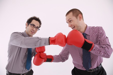 Businessmen with boxing gloves fightingの写真素材