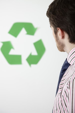 Man looking at recycling symbolの写真素材
