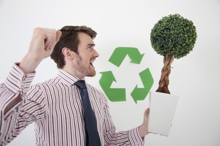 Man holding potted plant while shoutingの写真素材