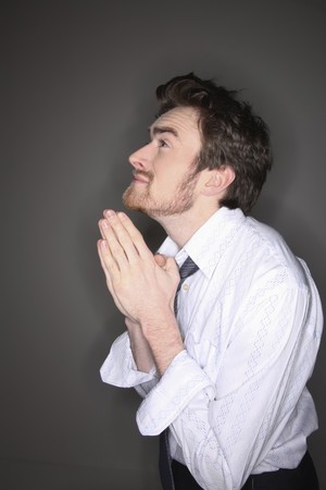Man with hands clasped prayingの写真素材