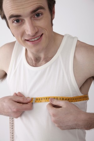 Man measuring his chestの写真素材