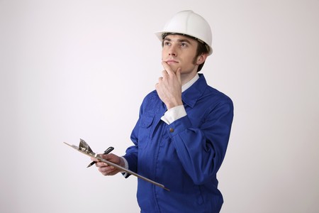 Man holding clipboard contemplatingの写真素材