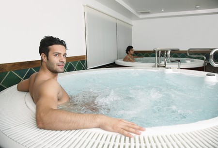 Men relaxing in hot tubの写真素材