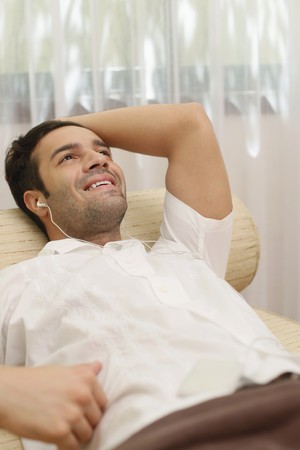 Man listening to music on portable mp3 playerの写真素材