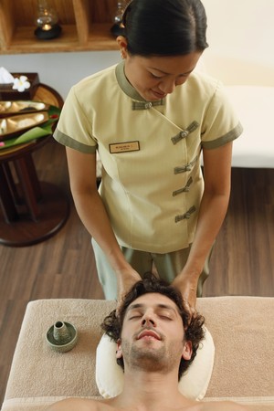 Massage therapist massaging man's headの写真素材