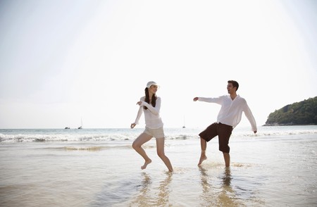 Man and woman playing on beachの写真素材
