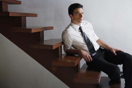 Businessman resting on the stairsの写真素材