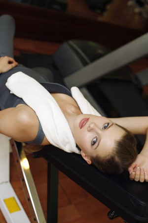 Woman resting at exercise machineの写真素材