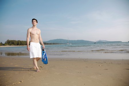 Man carrying snorkeling gearの写真素材