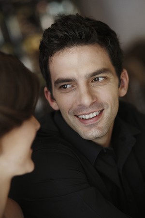 Man and woman smiling and looking at each otherの写真素材