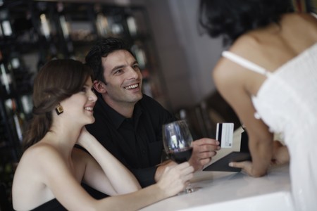 Man paying the bill with credit cardの写真素材