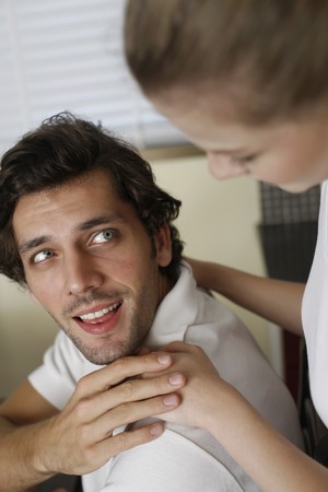 Woman with hands on man's shouldersの写真素材