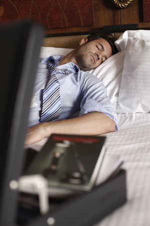 Businessman sleeping after readingの写真素材