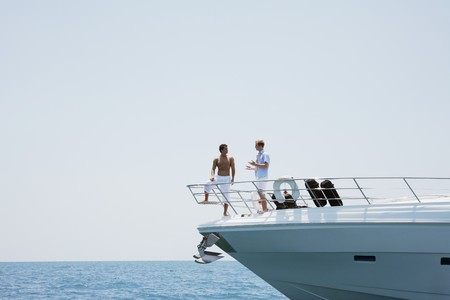 Men talking on yachtの写真素材