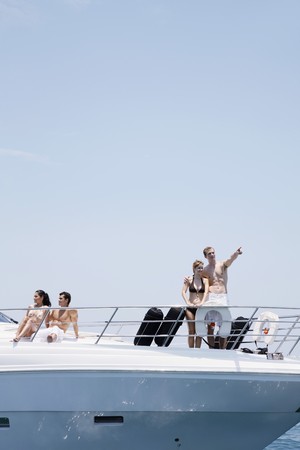 Couples relaxing on yachtの写真素材