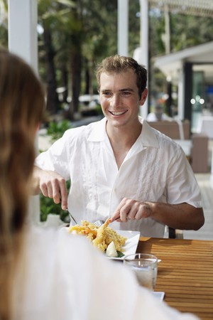 Man and woman having lunch at restaurantの写真素材