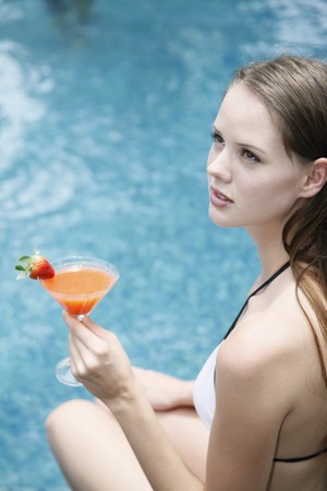 Woman holding a glass of cocktailの写真素材