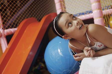 Girl in indoor playground, looking upの写真素材