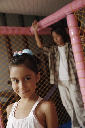 Girl in indoor playground, smilingの写真素材