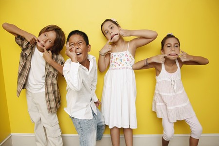 Boys and girls making funny facesの写真素材