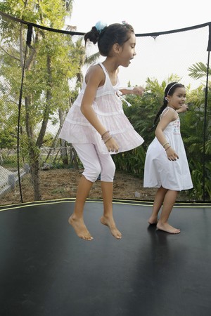 Girls jumping on a trampolineの写真素材