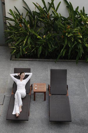 Woman relaxing on a lounge chairの写真素材