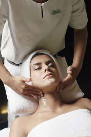 Woman in health spa, having her face washedの写真素材