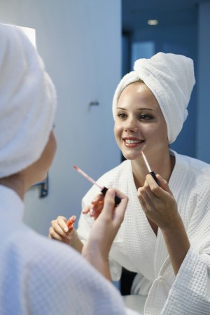 Woman applying lip glossの写真素材
