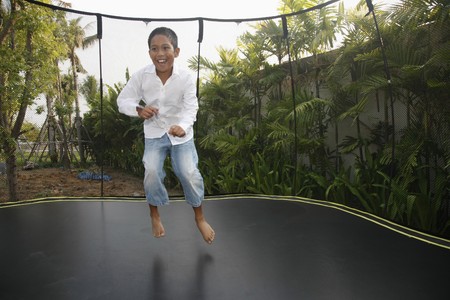 Boy jumping on a trampoline