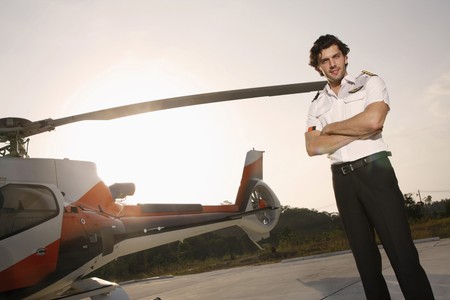 Pilot standing beside a helicopterの写真素材