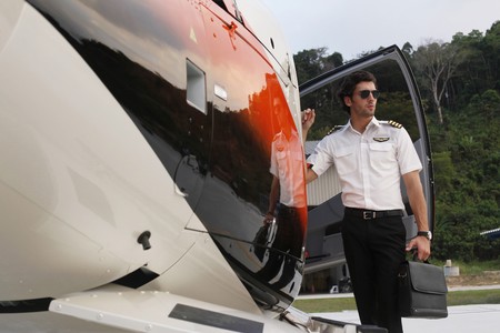 Pilot waiting by the helicopterの写真素材