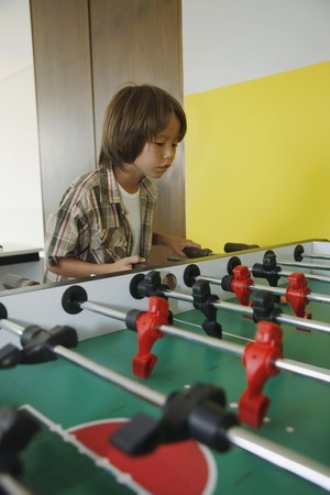  Boy playing table footballの写真素材