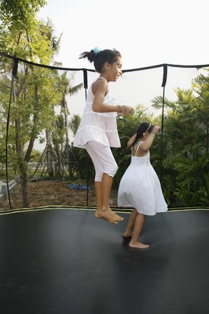 Girls jumping on a trampolineの写真素材