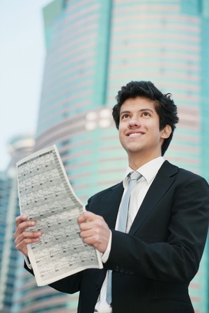 Businessman reading newspaperの写真素材