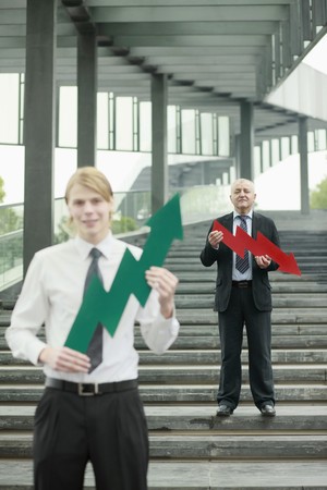Businessmen with arrow signsの写真素材