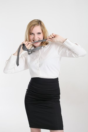 Businesswoman biting her tieの写真素材