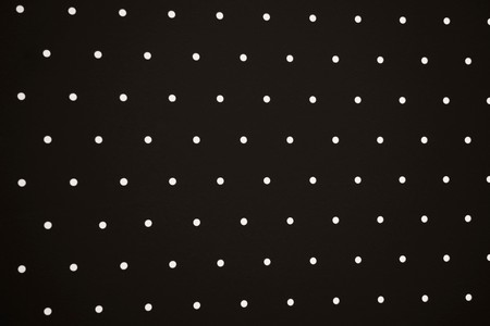 Close-up of holes on metal surfaceの写真素材