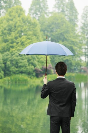 Businessman with an umbrellaの写真素材