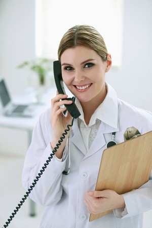 Doctor talking on the phoneの写真素材