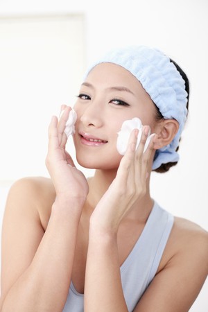 Woman cleansing her faceの写真素材