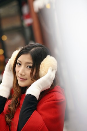Woman wearing ear muffs and glovesの写真素材