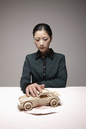 Woman with hand on toy carの写真素材